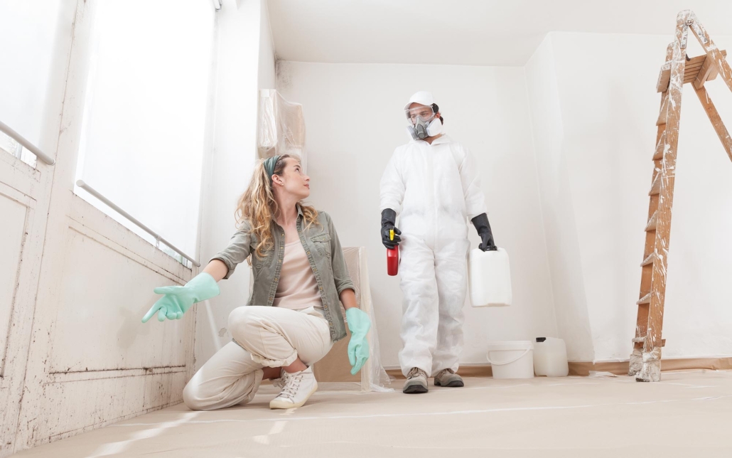 Two people working on house analyzing mold issue