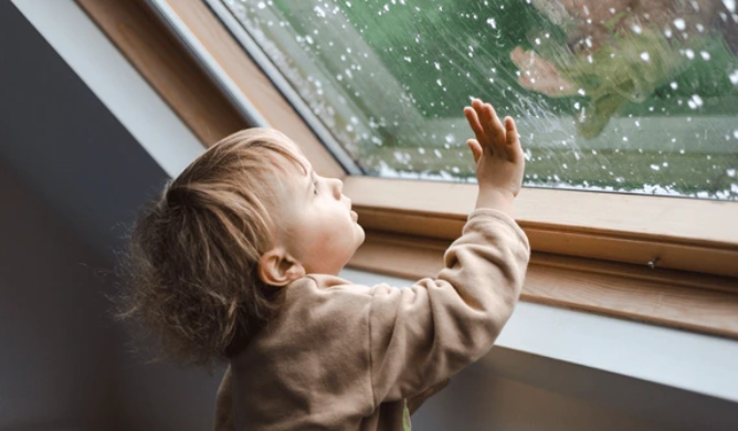 5 Powerful Reasons Lead Paint Removal Leon Valley TX Cannot Wait ; and What Every Homeowner Must Do Now 2 Young child near old painted window; lead paint removal Leon Valley TX protects vulnerable families