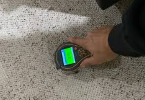 7 Proven Signs You Need Water Damage Experts Before It's Seriously Too Late 2 water damage experts inspecting moisture levels on drywall in San Antonio home